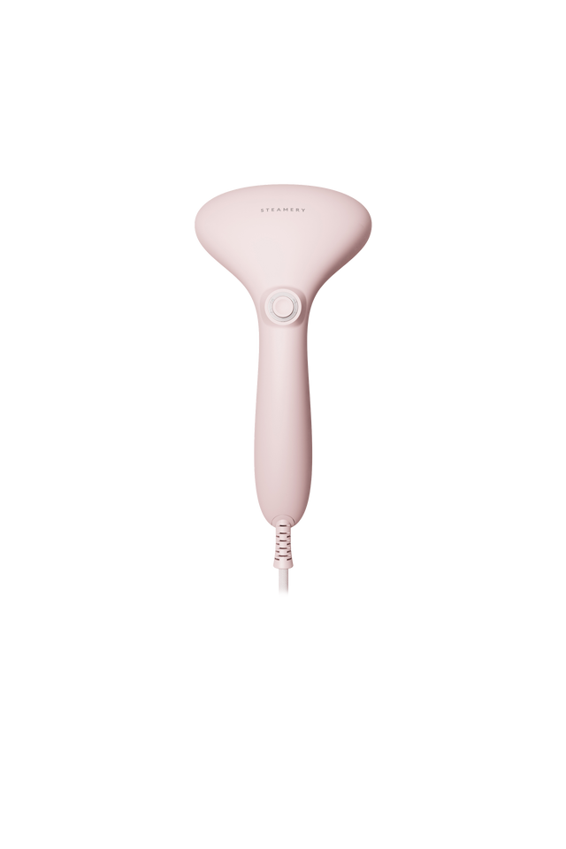 Pink handheld steamer on a white background