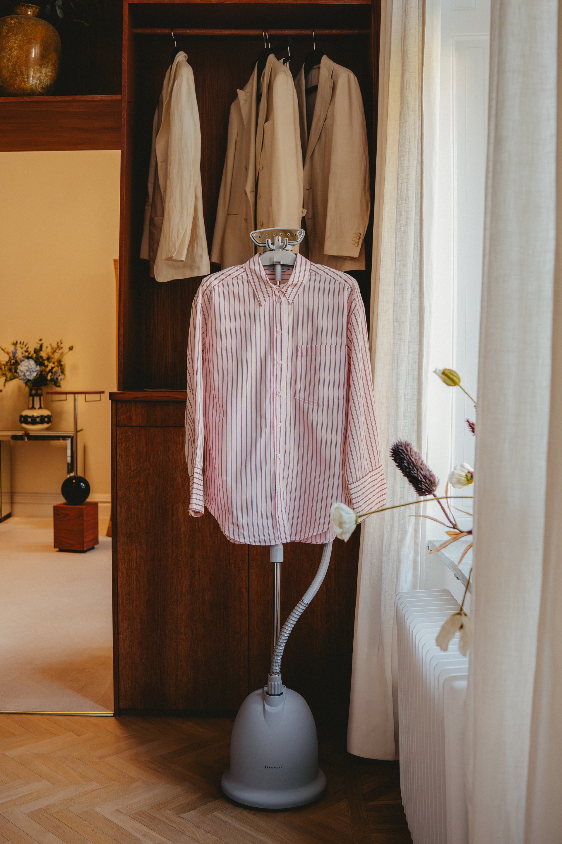 Grey Steamer with a shirt hanging on it in a closet