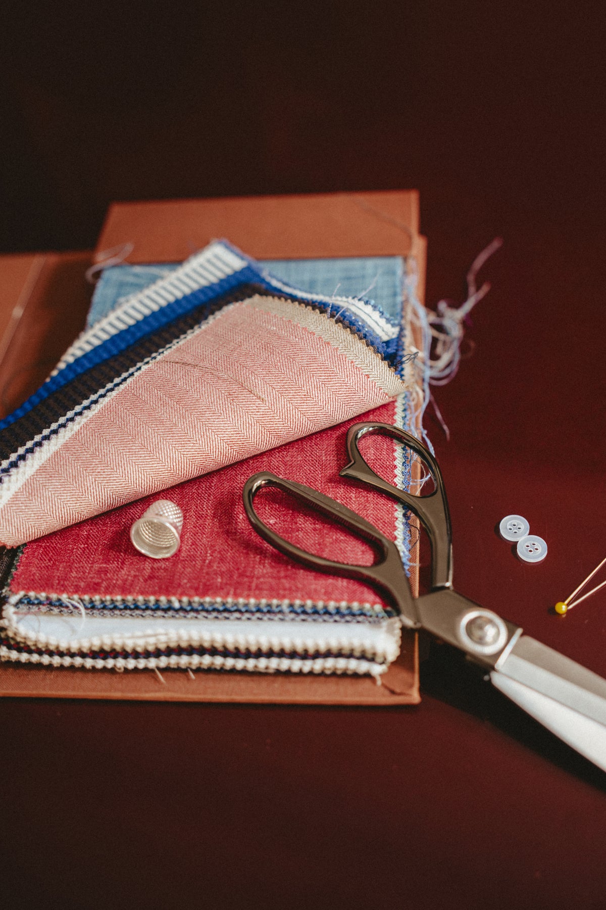 Swatches of textiles and pair of scissors