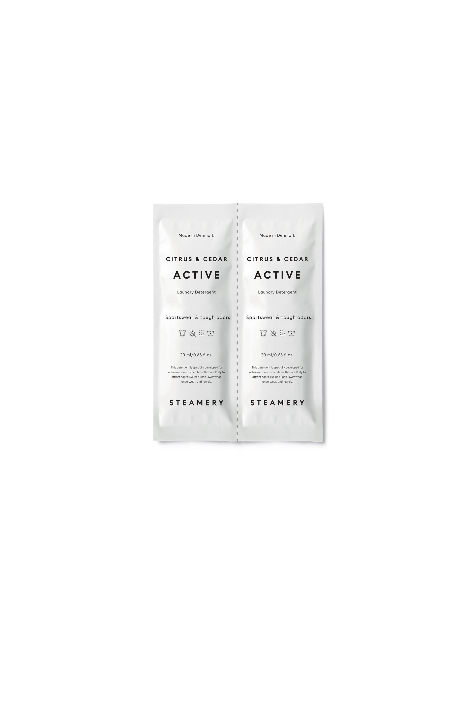 Two laundry detergent sachets of Steamery Citrus & Cedar Active on a white background