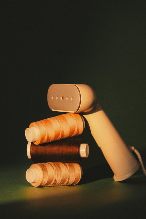 steamer leaning on thread spools