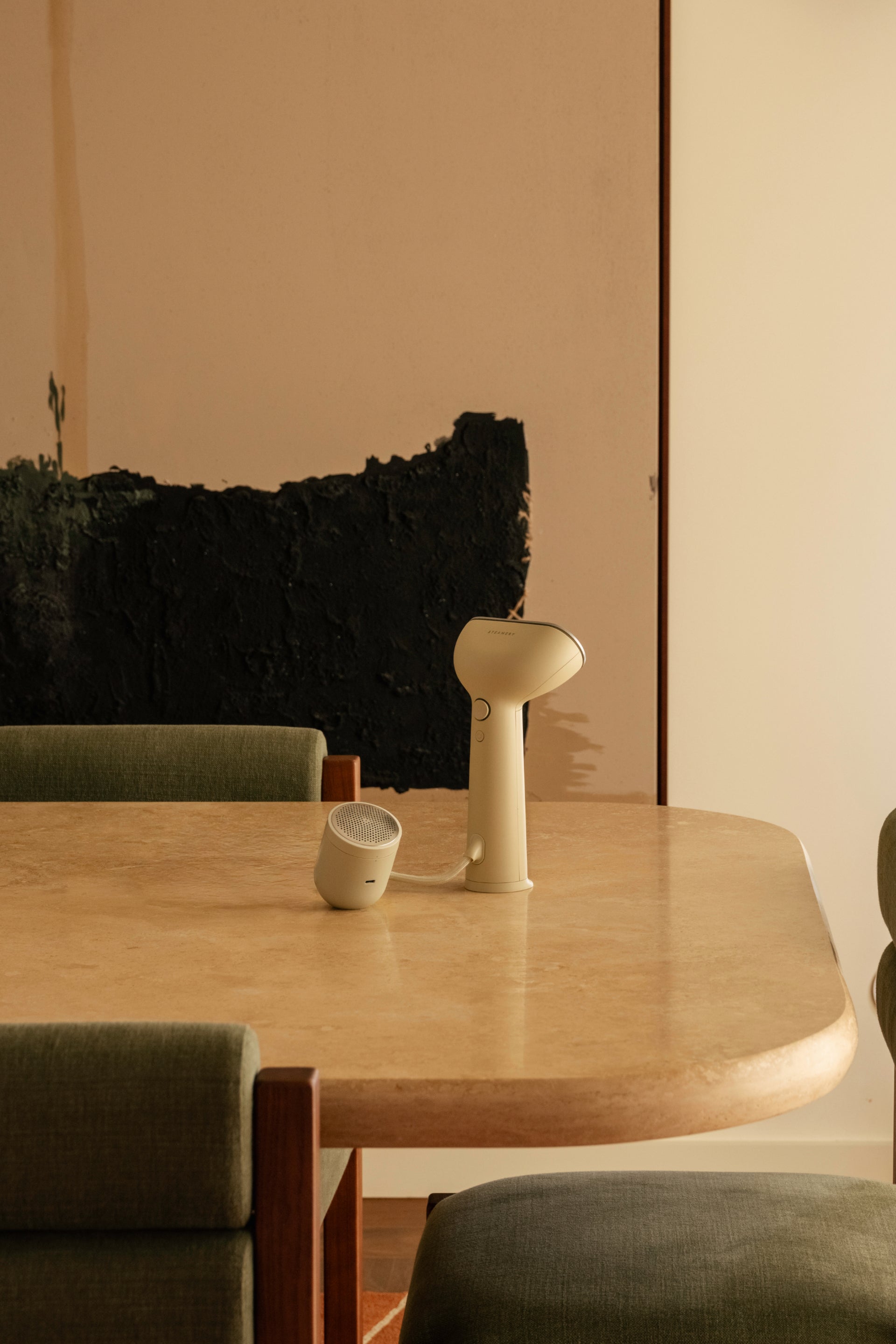 Beige steamer and fabric shaver on table
