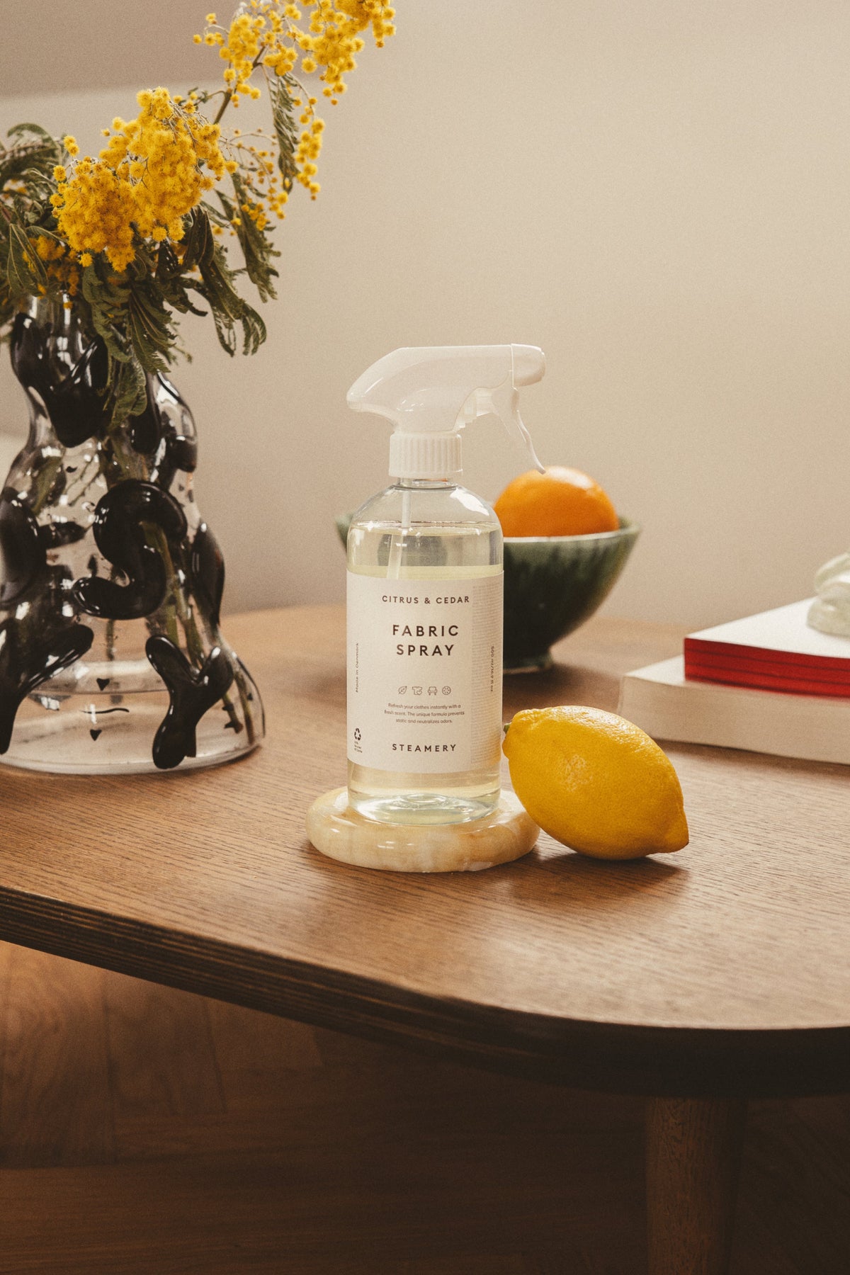 Fabric spray on a table with lemon leaning on it