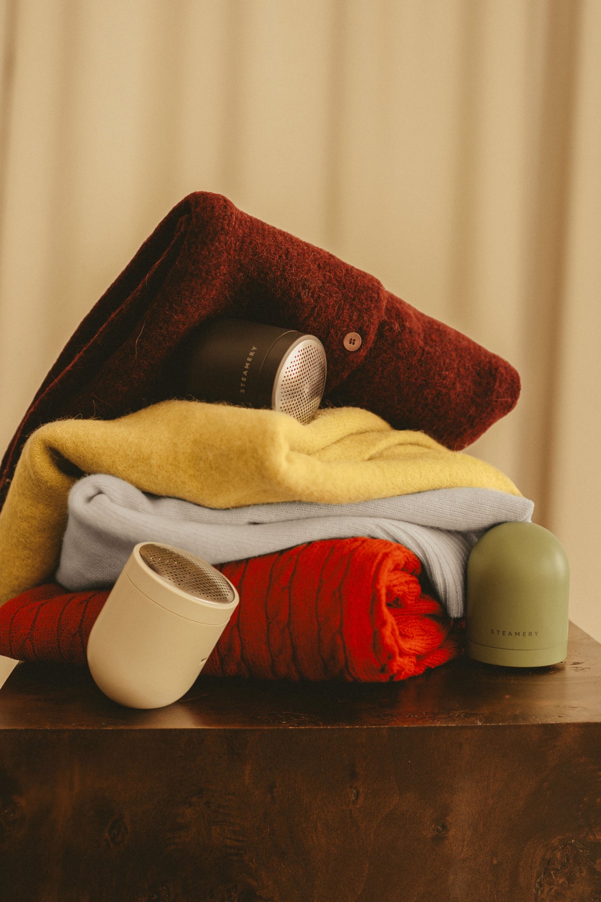 3 fabric shavers on a stack of knits