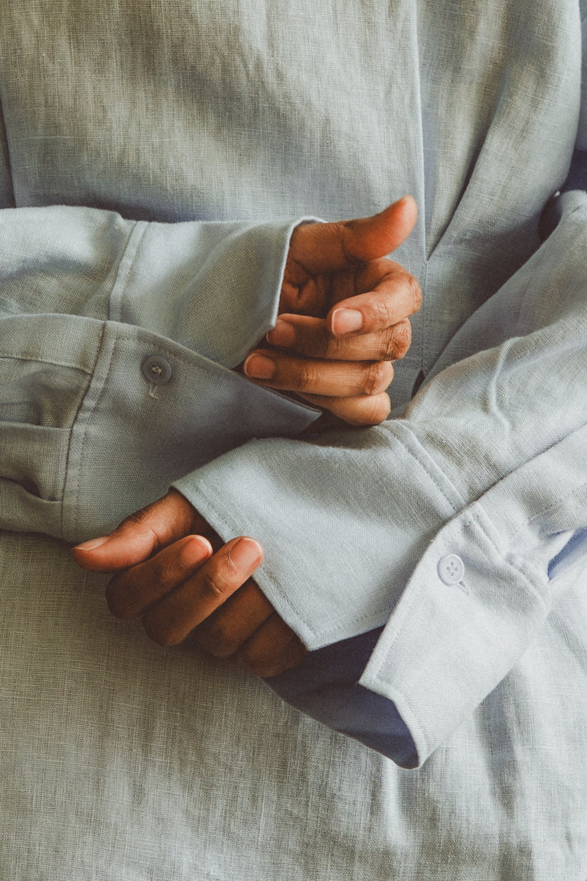 close up hands of person wearing a shirt