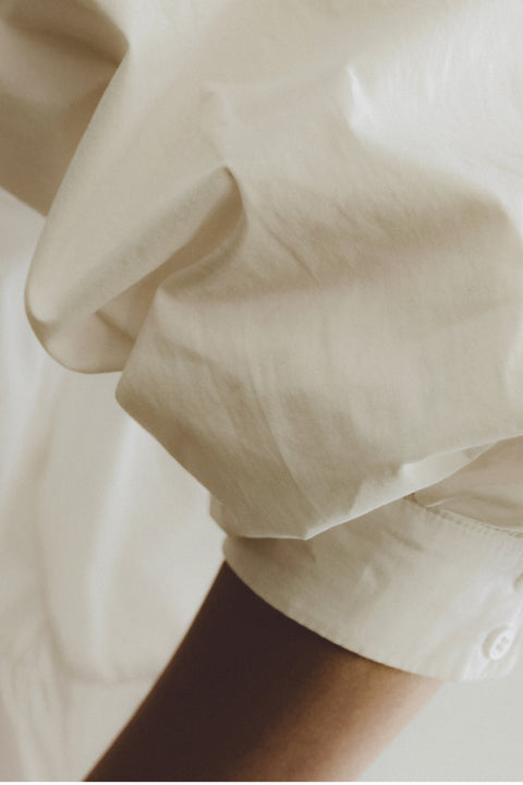 white shirt sleeve and an arm