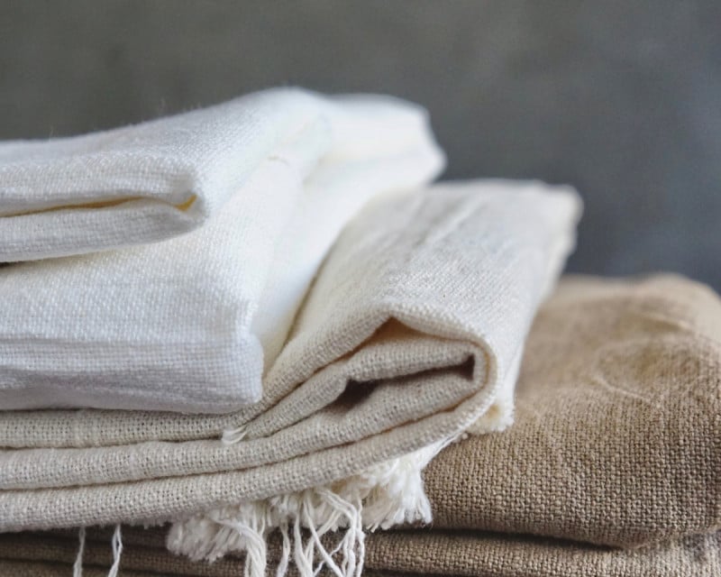 A pile of folded linen tablecloths